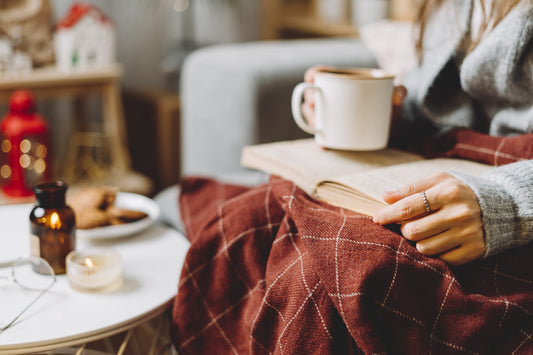 Cozy winter self care routine with a warm drink and reading for a healthy January