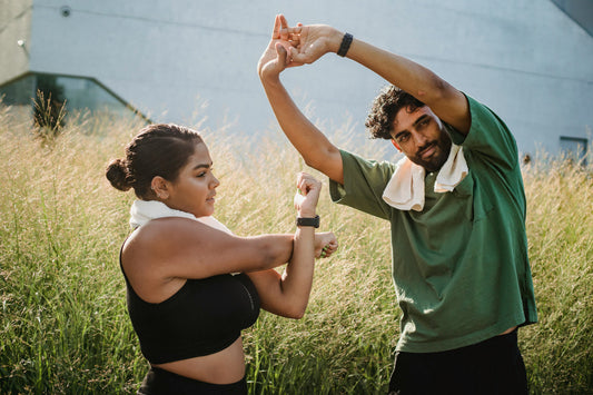 Adults stretching outdoors to support flexibility, circulation, and daily wellness routines in January