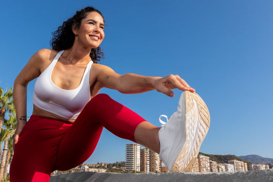 Woman stretching outdoors before exercise, symbolizing daily wellness habits and holistic support with Andrographis supplementation.