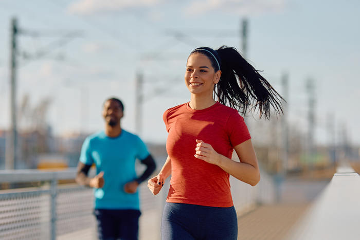 Woman jogging outdoors to represent energy, immunity, vitality, and the wellness benefits of zinc in an active lifestyle