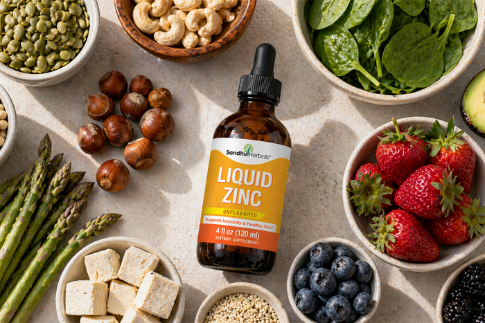 Liquid zinc supplement bottle surrounded by fresh fruits, vegetables, nuts, and seeds representing nutritional support for wellness and immunity.