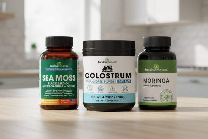 Sandhu Herbals Sea Moss, Colostrum, and Moringa supplements on wooden table for gut and digestive wellness.