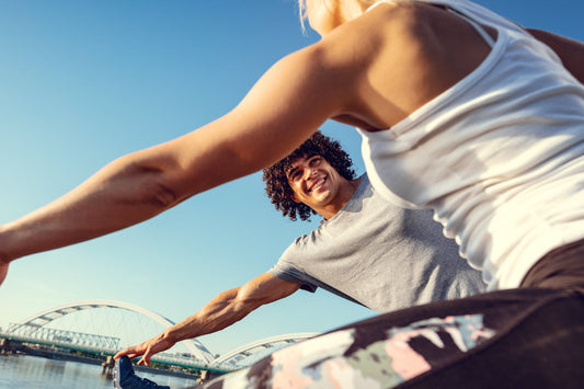 Active adults exercising outdoors in sunny weather, representing physical activity and healthy movement for supporting joint mobility and flexibility.
