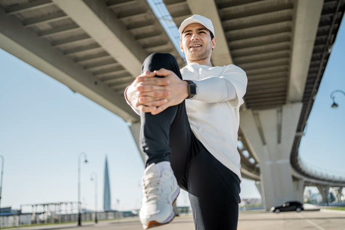 Man stretching before exercise outdoors, representing flexible living, healthy joints, mobility support, and the benefits of integrating turmeric daily.
