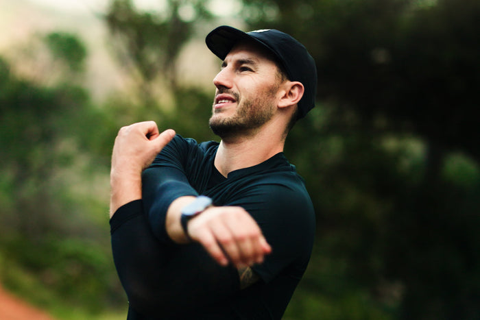 Man stretching outdoors, representing an active lifestyle and the role of zinc in supporting immune function, energy, and overall wellness.