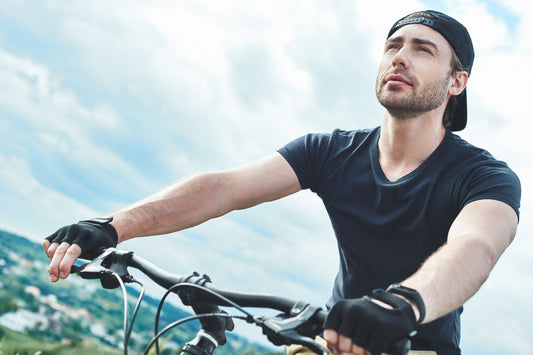Active man cycling outdoors, representing an active lifestyle supported by balanced nutrition and adequate zinc for cellular wellness.
