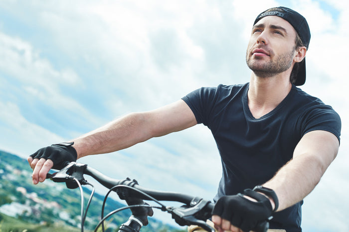 Active man cycling outdoors, representing an active lifestyle supported by balanced nutrition and adequate zinc for cellular wellness.