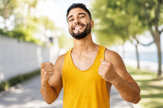 Smiling man celebrating an active lifestyle, representing the potential wellness benefits of Shilajit for energy and overall vitality.